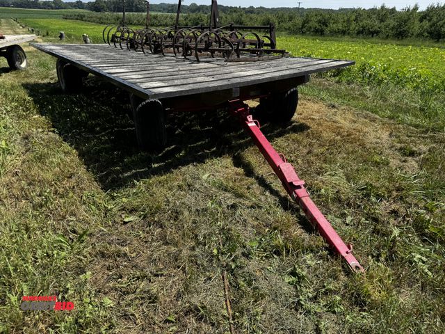Lot 1-7009 - (1) 18' x 9' wide flat bed wagon, Horst running gear with 11L-15SL tires, pin style hitch, does not ...