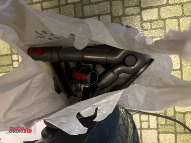 Lot 1-3109 - (1) Titan vacuum with attachments and (1) Dyson cordless vacuum with wall mount, attachments and cha...