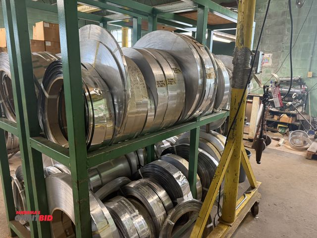 Lot 1-18680 - (2) 93" length x 87" height x 24" depth square tube steel racks, both with assorted rolls of metal, ...