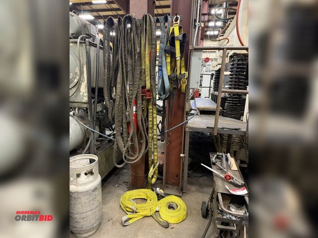 Lot 1-15399 - Large lot of assorted nylon slings, lifting straps, tow straps, and safety harness with lanyard.