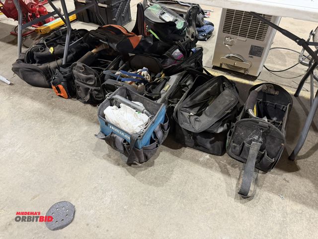 Lot 1-18631 - Large lot of assorted used tool bags, some include assorted screwdrivers, and other tools.