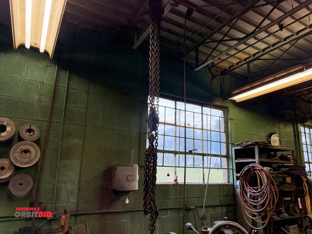 Lot 1-18527 - (1) manual, pulley type chain hoist, capacity unknown, winning bidder responsible for proper removal...