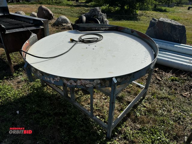 Lot 1-6936 - (1) turntable style packing table, 5' diameter x approx. 32.5" tall, 120V motor.