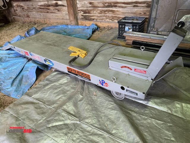 Lot 1-8157 - (1) Handy pneumatic motorcycle lift table with ramp, 80" x 24" with a 20" ramp, foot pedal controls,...