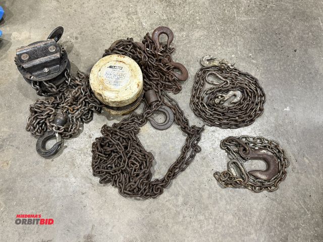 Lot 1-18640 - (1) Larin 1-ton chain hoist, (1) unknown size chain hoist, and (2) small chains.