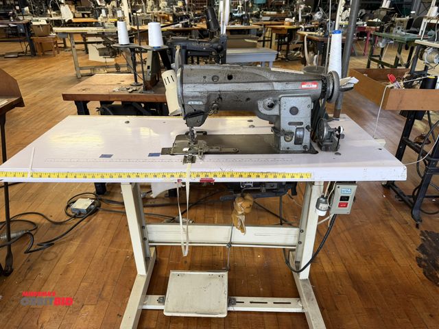 Lot 1-4691 - (1) Singer, model 457G135, commercial sewing machine on a Singer power table, 1/2 HP, 3 phase motor,...
