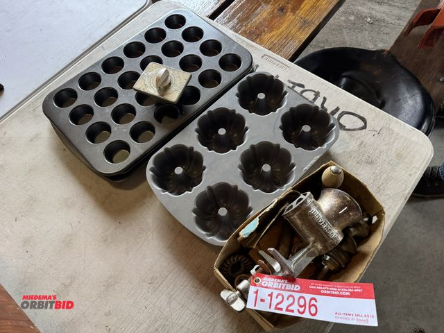 Lot 1-12296 - Lot of assorted kitchen items, includes Universal table top mount grinder, and assorted muffin pans.