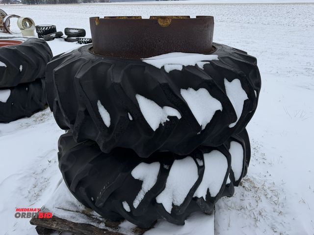 Lot 1-11646 - (1) set of clamp on duals, size 18.4-34, tires are cracked and weather checked.