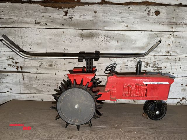 Lot 1-8340 - (1) vintage Gilmore traveling metal sprinkler shaped like a tractor.