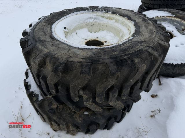 Lot 1-11663 - Lot of (2) Titan 12-16.5 skid steer tires on 6-bolt rims.