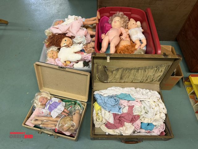 Lot 1-12165 - Large assortment of dolls and doll clothing.