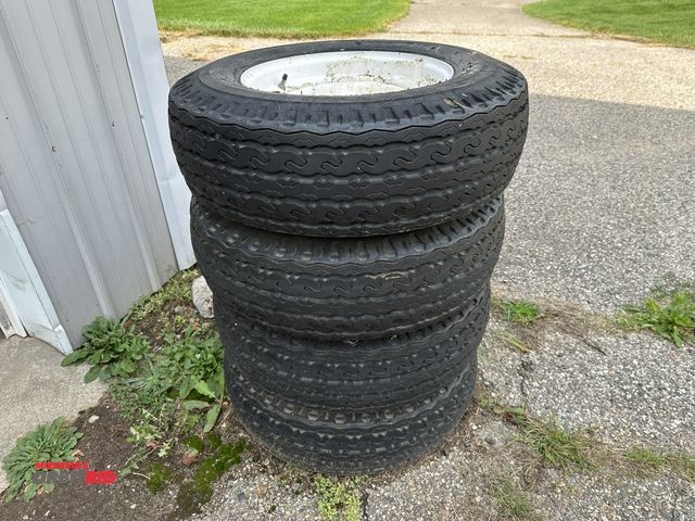 Lot 1-591 - Lot of (4) 8.75-16.5 LT tires on 8-bolt rims, tires are used, and (1) 205/75R15 trailer tire on 5-bo...
