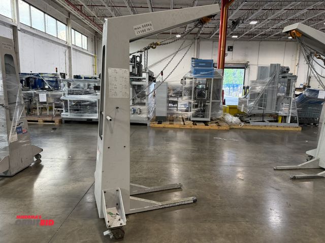 Lot 1-5440 - (1) Muller Martini, 1100 lb. max capacity crane/hoist, has broken wheel on one side, wheel replaceme...