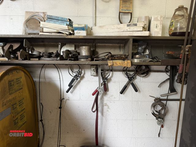 Lot 1-18595 - Lot of assorted filter wrenches, muffler clamps, exhaust caps, and more.