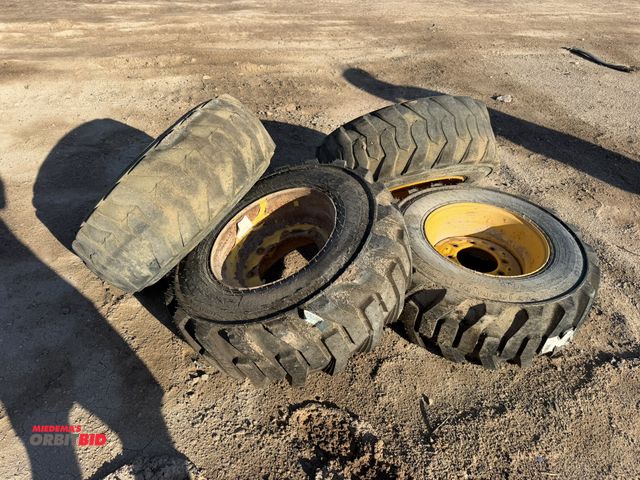 Lot 1-18170 - Set of skid steer tire and rims, 12-16.5 NHS, 8-lug, (2) with new tires (2) with new