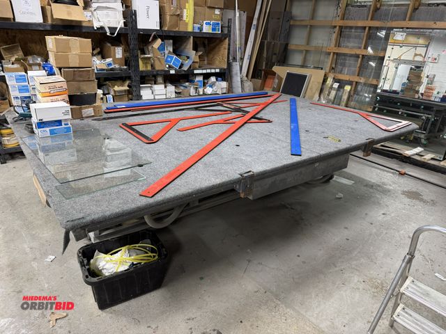 Lot 1-16592 - (1) layout table, approx. 8' wide x 12' long x 36" tall, (2) 36" wide paper dispensers, (1) 24" wide...