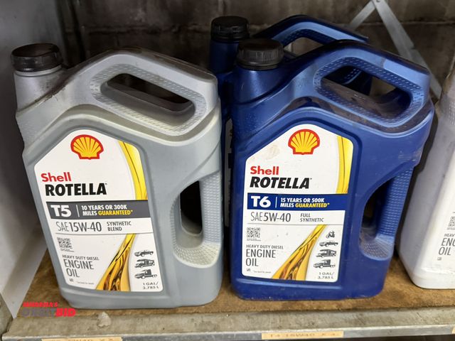 Lot 1-1224 - Entire contents of 2 shelves shown in photos, includes (1) partial gallon of Shell Rotella T5 SAE15W...