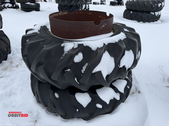 Lot 1-11642 - (1) set of clamp on duals with 16.9-28 tires, tires are cracked and weather checked.