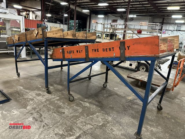 Lot 1-14371 - (1) 60" width x 96" depth heavy duty tilted steel table on wheels, high point at approx. 55" and low...