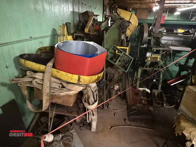 Lot 1-18483 - Large lot of assorted items, includes coil racks, tables, electric control panels, manual presses, b...