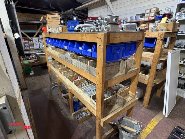 Lot 1-4345 - Contents of 2-sided wood shelf, includes assorted 1" and 3/4" electrical items, 1-hole straps, condu...