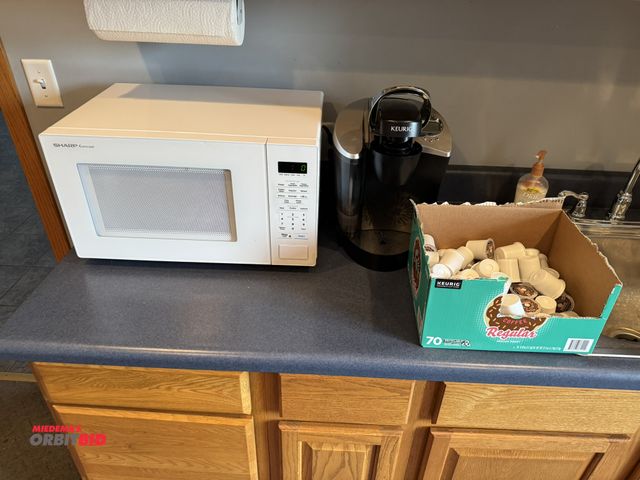 Lot 1-19590 - (1) Keurig single cup coffee maker with a partial box of Keurig Donut Shop Coffee, and (1) Sharp Car...