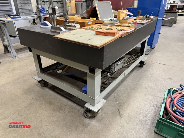 Lot 1-15203 - (1) granite surface table with metal casters, 72" length x 48" width x 35.5" height, approx. 8" thic...