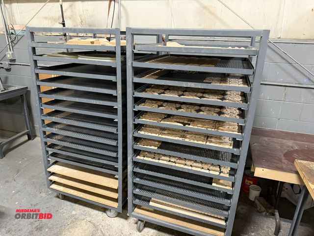 Lot 1-18654 - Lot of (2) rolling product racks with slide out mesh style shelves, 36" x 34" x 67", includes assort...