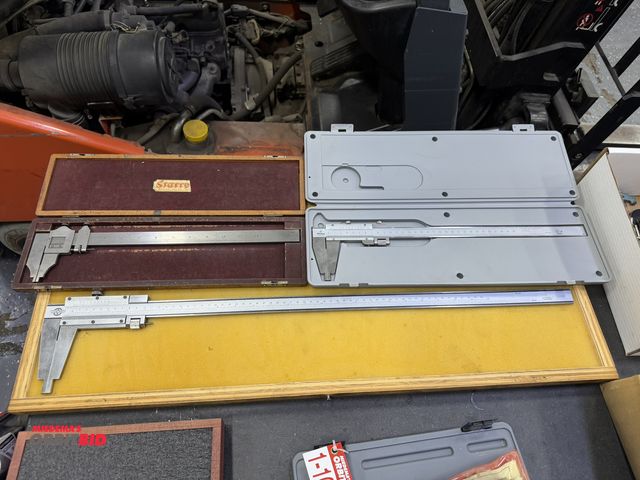 Lot 1-10285 - (1) Kanon 24" caliper with wood case, (1) Starrett 12" caliper with case, and (1) Mitutoyo 30cm cali...