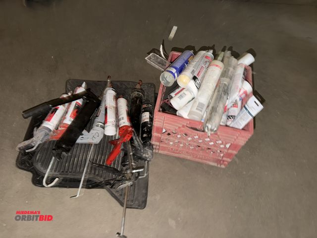 Lot 1-13183 - Large lot of assorted caulk guns and caulk.