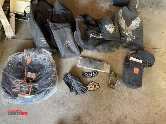 Lot 1-8372 - Lot of assorted Harley Davidson related items, includes various bags, carrying cases, patches, glove...