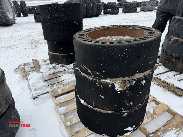 Lot 1-11696 - Lot of (7) solid skid steer tires on 8-bolt rims.