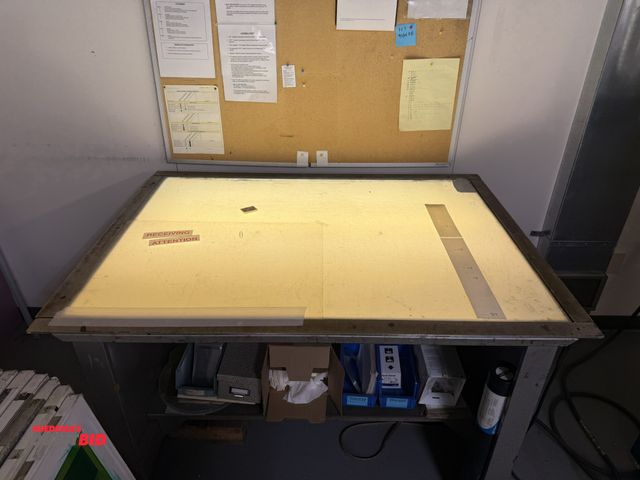 Lot 1-18989 - (1) lighted drafting table, approx. 54" x 40", fluorescent style bulbs, includes wall mounted corkbo...