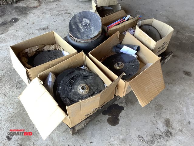 Lot 1-19050 - Skid lot of assorted planter parts which includes Seed Discs, Press wheels, Soybean planter springs ...