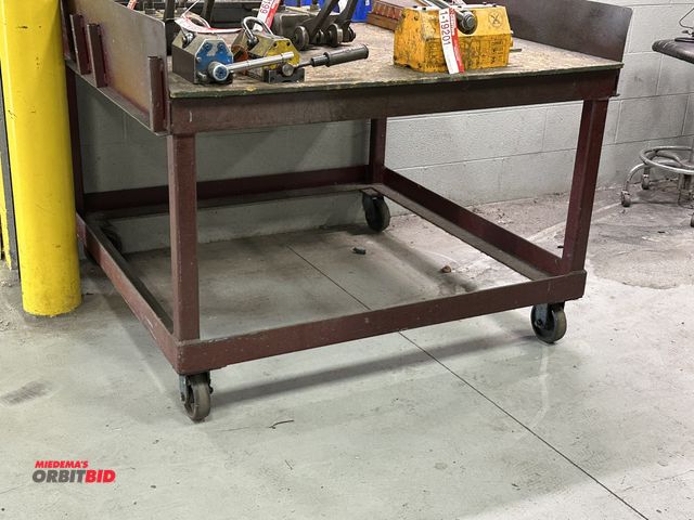 Lot 1-19203 - (1) 48" width x 32" height x 48" depth heavy duty steel table with OSB top and 5.5" tall steel shiel...