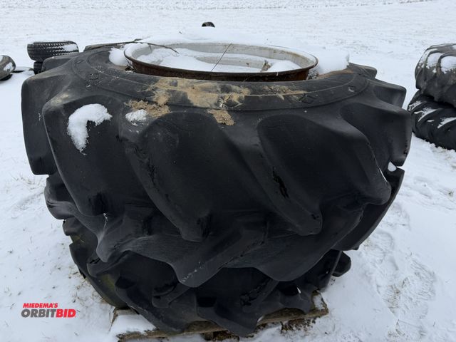 Lot 1-11648 - (1) set of 23.1-30 duals mounted on 10-bolt rims, tires are cracked and weather checked.