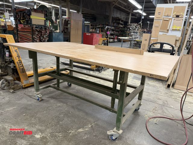 Lot 1-16420 - (1) rolling, manual, adjustable height shop table with wood top, 85" x 49" top, on casters.