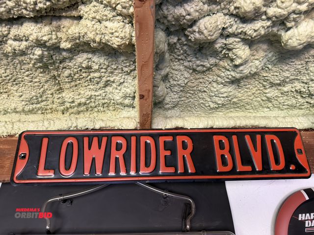 Lot 1-8189 - (1) 24" x 4.5" "Low Rider Boulevard" reproduction street sign.