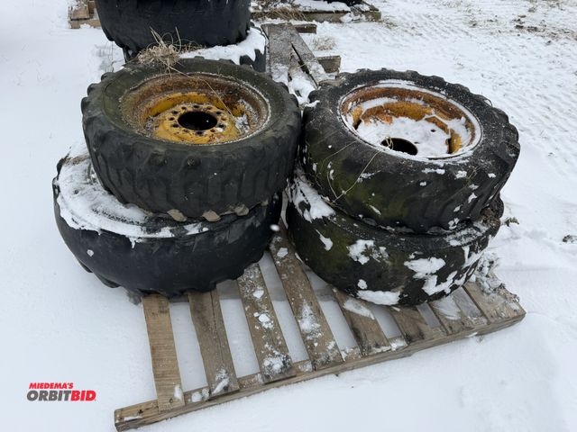 Lot 1-11694 - Lot of (2) 10-16.5 skid steer tires on 8-bolt rims, and (2) 27 x 6 x 8.5-15 tires on 6-bolt rims.