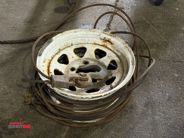 Lot 1-1282 - (1) approx. 14" diameter rim with approx. 30' of steel wire towing cable with hook on one end.