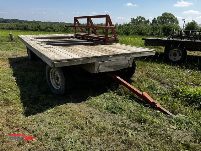 Lot 1-7010 - (1) 16' x 99" wide flat bed hay wagon, pin style hitch, 235/85R16 tires, decking has 1 small hole, d...
