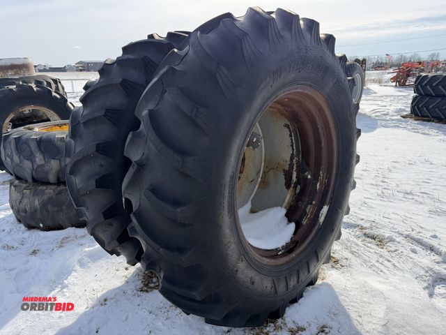 Lot 1-11631 - (1) used set of Titan 16.9-34 dual tires on 10-bolt rims, tires are weather checked.