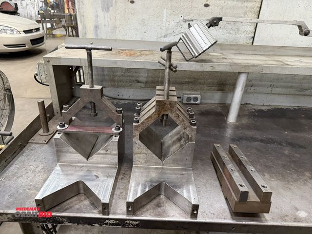 Lot 1-15168 - Lot of (2) V-block hold down brackets, each is 8" wide x approx. 12 1/4" long x 6" to top.
