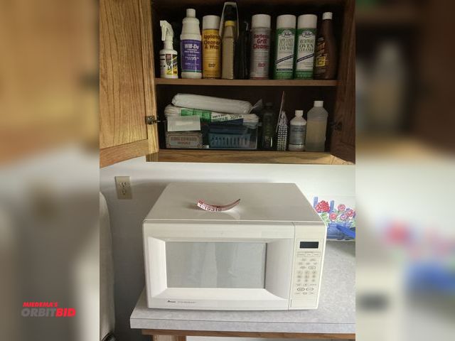 Lot 1-19319 - (1) Amanda radar range microwave with iron board and contents of items in cabinet includes microwave...