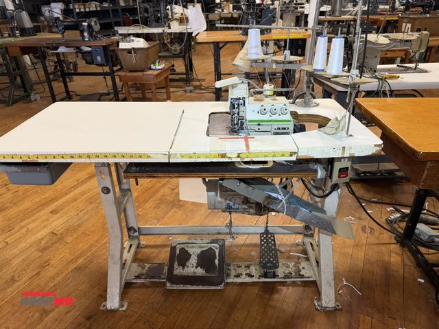 Lot 1-4678 - (1) Juki, model MO-2404, industrial overlock sewing machine with power table, 3 phase, 230/380V moto...