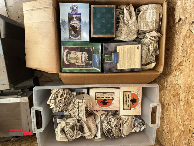 Lot 1-14308 - (1) plastic tote, and (1) box of collectible beer steins (some with original packaging, some wrapped...