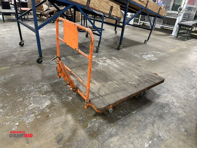 Lot 1-14372 - (1) 54" length x 12" height x 48" depth steel framed tugger cart, wood decking, 32" tall handle.