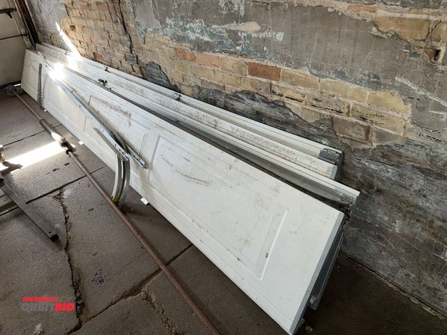 Lot 1-1105 - Panels for an approx. 16' wide x7’ tall vinyl garage door with rails, said to be a complete unit. In...