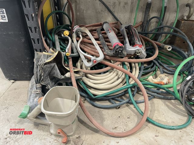 Lot 1-18853 - Large lot of assorted garden hoses and sprinklers.