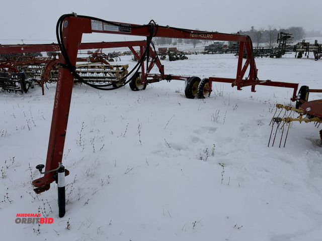 Lot 1-10402 - (1) New Holland hydraulic steerable tandem rake hitch, model 252, S/N 276665, 215/70R15 tires.
